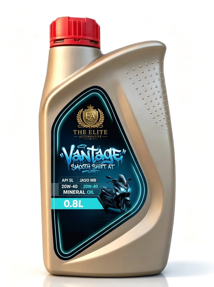 A 0.8L bottle of The Elite Vantage Smooth Shift AT motorcycle mineral oil, featuring a metallic gold body, a red cap, and a black and blue label with a motorcycle graphic.